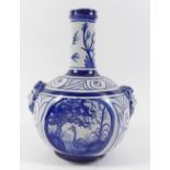 A Delft bottle form vase in 18th century style with masks to shoulders, 19cm high