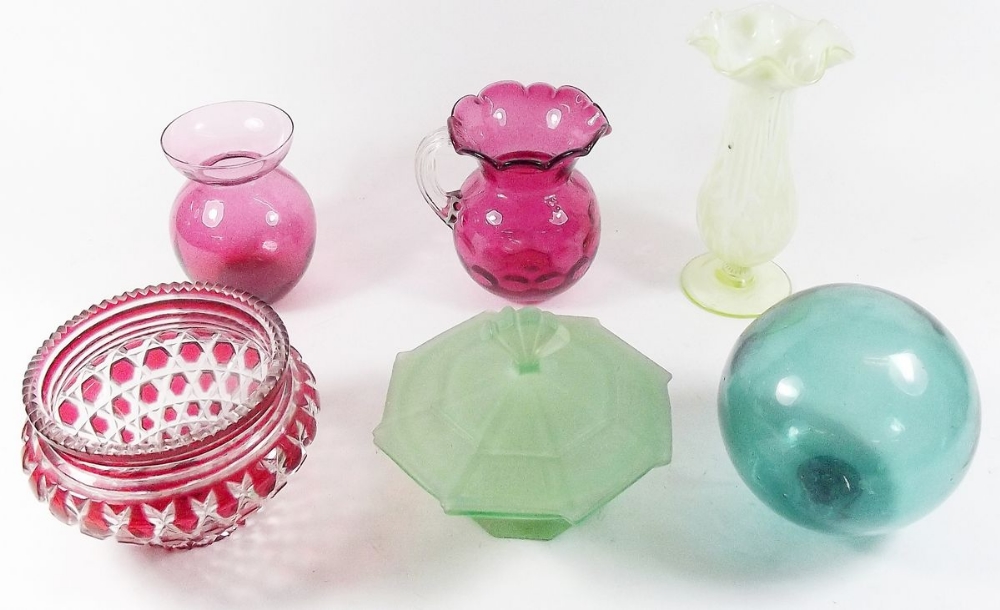 A group of coloured glass to include cranberry glass vase and jug, a Vaseline glass vase, a glass