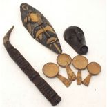 Two African wooden tribal masks, four Zambian tribal wooden spoons and a ceremonial musical wooden