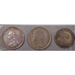 Three UK silver coins including: William III sixpence 1699, third bust large crowns, George III