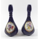 A pair of Vienna style vases painted reserves of flowers on a blue ground, 20cm tall