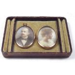 A pair of Edwardian watercolour on ivory miniature portraits of a gentleman and lady, gilt metal