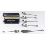 A silver tie pin, various silver spoons and a butter knife