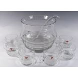 A glass punch bowl, cups and ladle