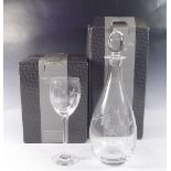 A Dartington glass decanter and four tall stemmed wine glasses engraved fuchsia