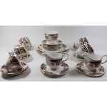 A Colclough tea set comprising nine teacups, ten saucers, twelve tea plates, two dinner plates, cake