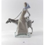 A Lladro figure of a woman with goat, 27.5cm high
