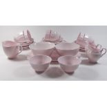 A Tuscan pink vintage teaset comprising six cups and saucers, three jugs, two sugar bowls, six tea