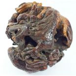 A Chinese root wood carving depicting a dragon and phoenix