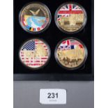 A presentation box containing four D Day enamel, gold plated commemoratives ref 70th anniversary