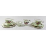 An Aynsley floral bachelors tea service including two cups and saucers, two tea plates, milk and