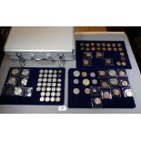 An aluminium coin collector case with keys containing numbers pre-decimal e.g halfpennies,