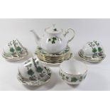 A Crown Staffordshire part tea service printed vine leaves comprising six cups and five saucers,