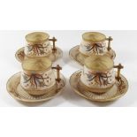 A set of four Belleek 1st period cups and saucers painted flowers on a gilt and cream ground