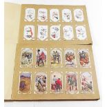 Cigarette cards: selection in two albums including 'Saronicks' (47/50) Wills/Players part sets