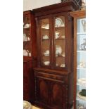 A Victorian mahogany bookcase of small proportions with two glazed doors over drawer and cupboard