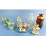 A collection of glass inkwells, baby bottle etc