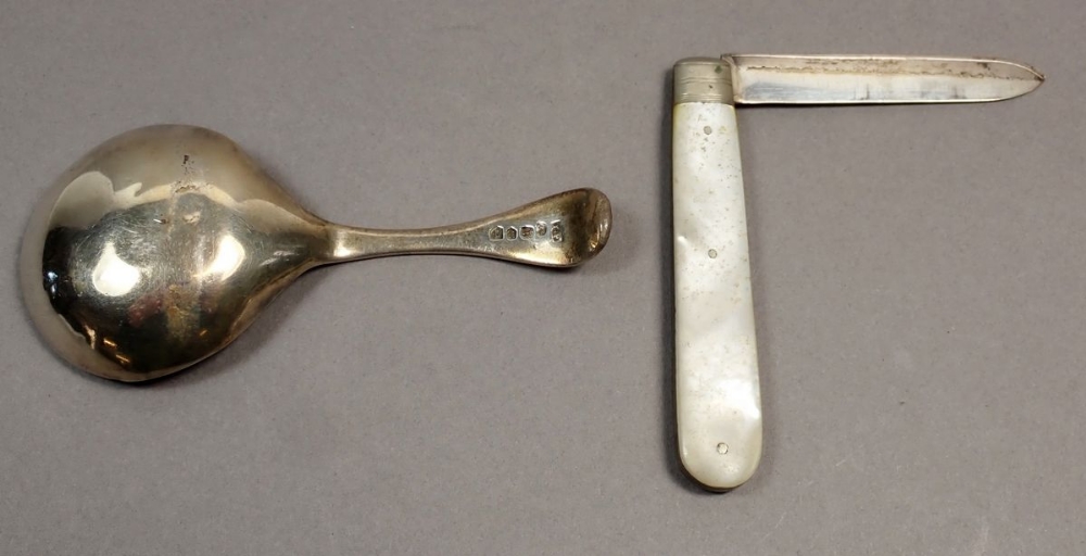 A Georgian silver caddy spoon with bright cut decoration, Birmingham 1829, a silver and mother of - Image 2 of 3