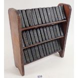 A set of miniature Shakespeare on fitted bookshelf