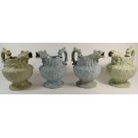 Two pairs of early Victorian mask jugs with stylised dolphin handles and spouts, 21cm tall