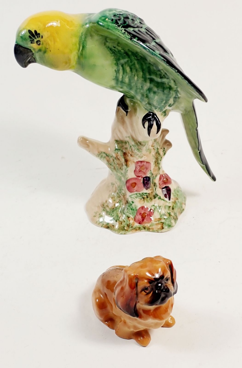 A Beswick parrot and a Pekinese dog