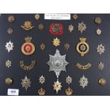 A collection of military insignia to the Worcestershire regiment with an officers P T Glengarry