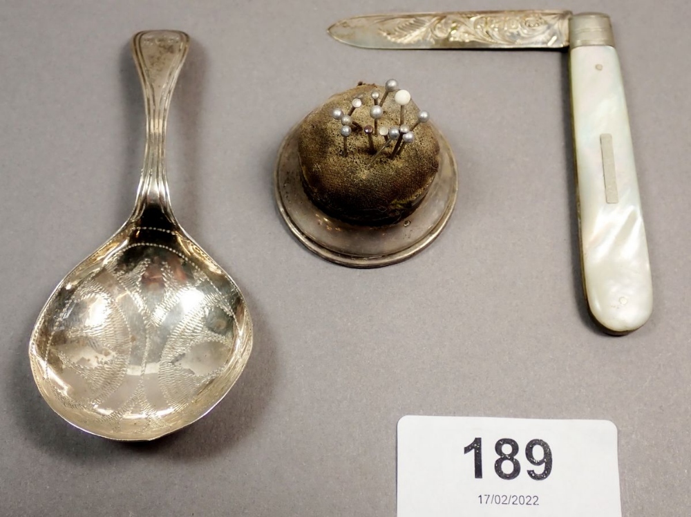 A Georgian silver caddy spoon with bright cut decoration, Birmingham 1829, a silver and mother of