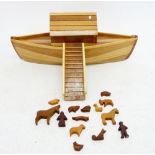 A hand carved wooden toy ark and set of carved animals, 69cm long
