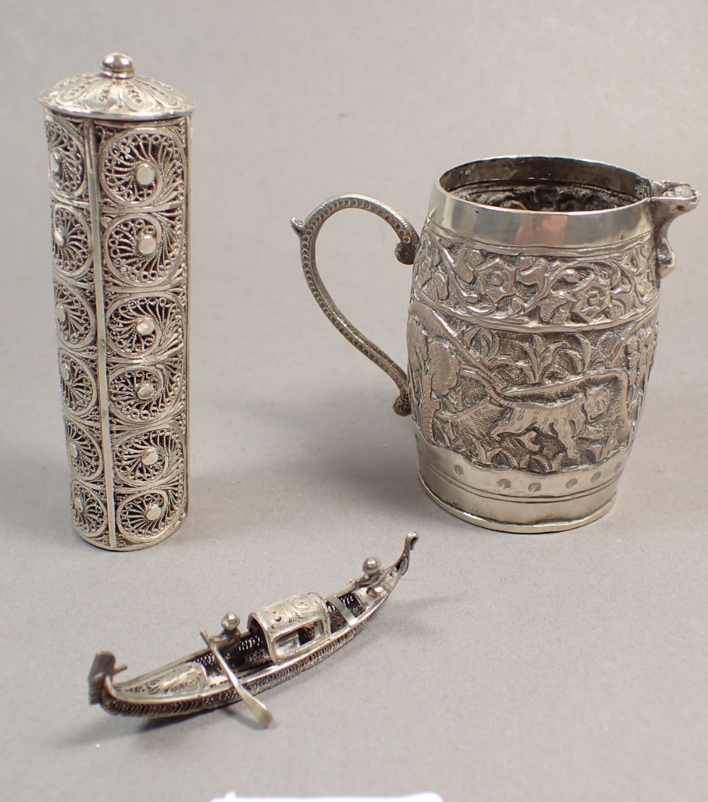 An Indian white metal cream jug, a filigree junk and a cylindrical box