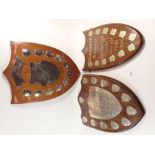 An oak lacrosse shield from Princess Helena College set with silver plaques and two similar, with