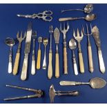 A group of silver-plated cutlery items, includes grape scissors, cake knife, jam spoons, bread forks