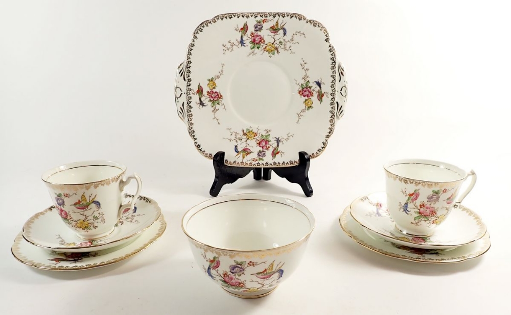 An Adderley tea service with bird and floral decoration comprising four cups and five saucers,
