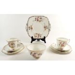 An Adderley tea service with bird and floral decoration comprising four cups and five saucers,