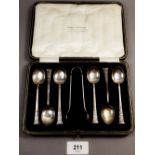 A cased set of six Egyptian style silver teaspoons and sugar tongs, Sheffield 1923, Maker William