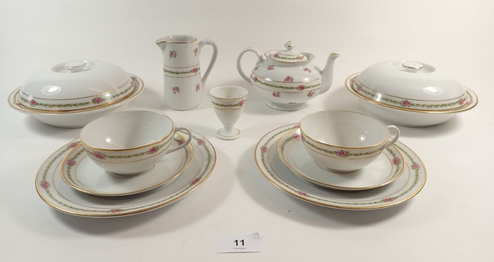 A Bauscher Bros tea service with rose printed borders comprising a teapot, milk, sugar, two egg