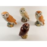 Three Beswick barn owls, one matt and the others glazed, approx 19cm high plus a Royal Doulton Tawny