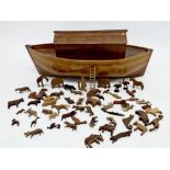 A large hand carved wooden ark and contents of carved wooden animals, 100cm long