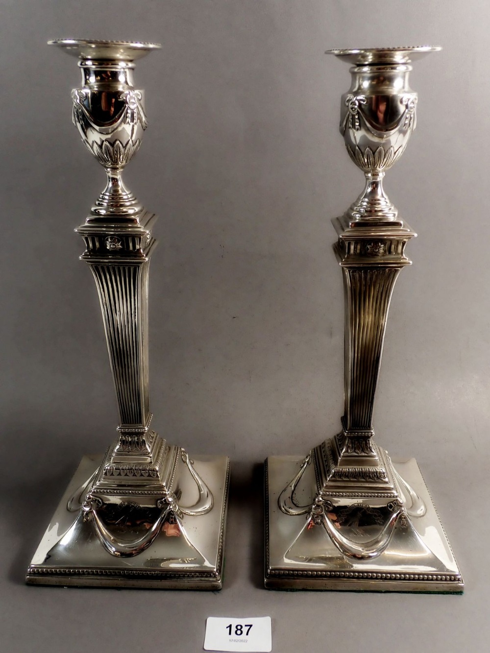 A pair of large Georgian silver Corinthian column form candlesticks with Neoclassical swags and