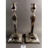 A pair of large Georgian silver Corinthian column form candlesticks with Neoclassical swags and