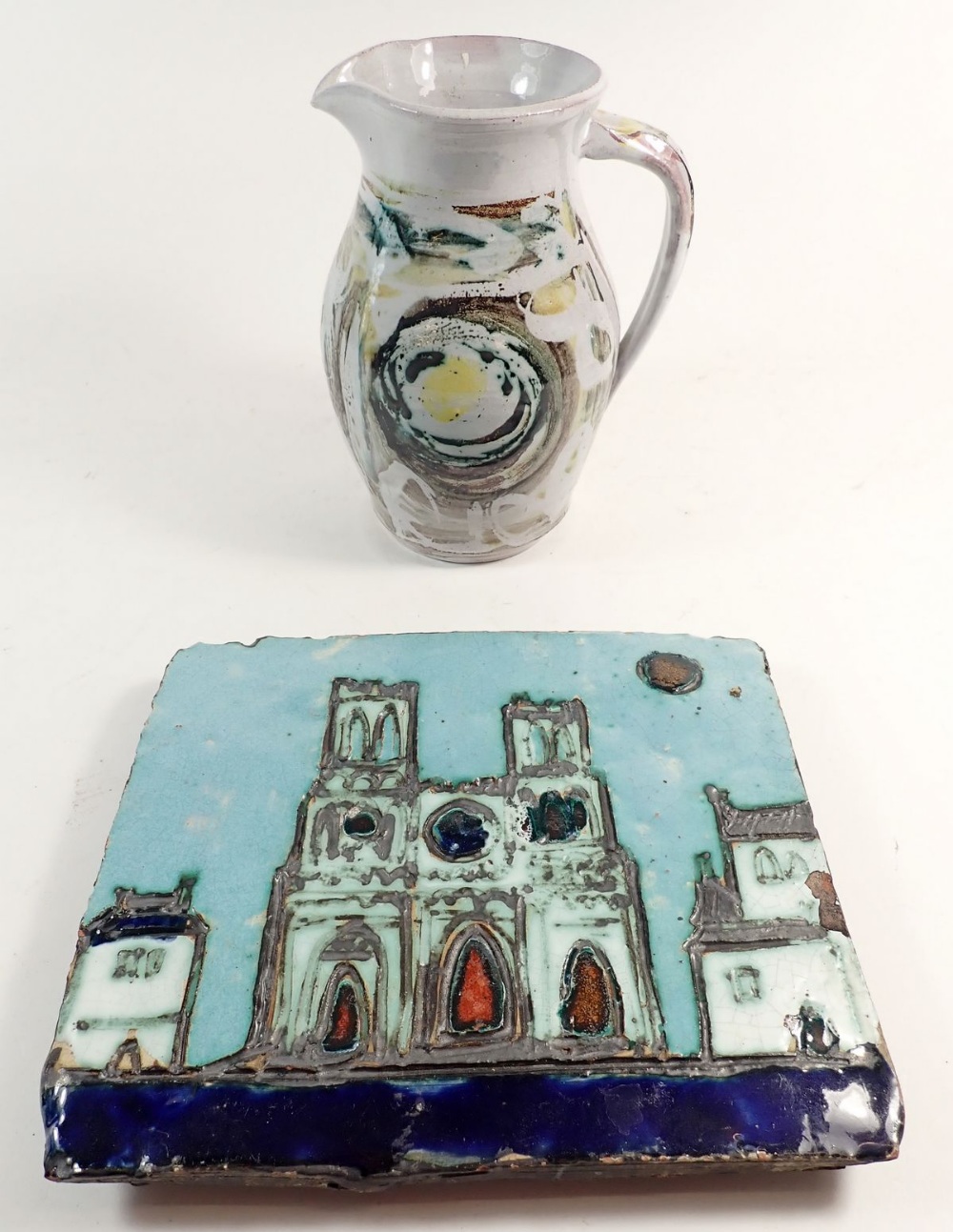 A studio pottery Wye Valley jug, 18cm and a pottery plaque by Adam Dworski, 8 x 21cm