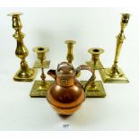 A pair of brass candlesticks, a Gurnsey jug and three other brass candlesticks