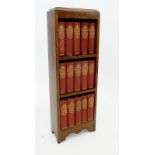 An oak bookcase with a set of Charles Dickens novels published by Waverley
