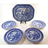 A Victorian blue and white willow pattern meat plate and four dinner plates