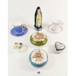 A Quimper figure of St Anne and various porcelain trinket boxes and two cabinet cups