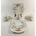 A Williamson Heathcote tea service decorated birds and branches, six cups and saucers, six tea