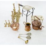 A box of copper and brass including copper kettles, trivet and candlesticks