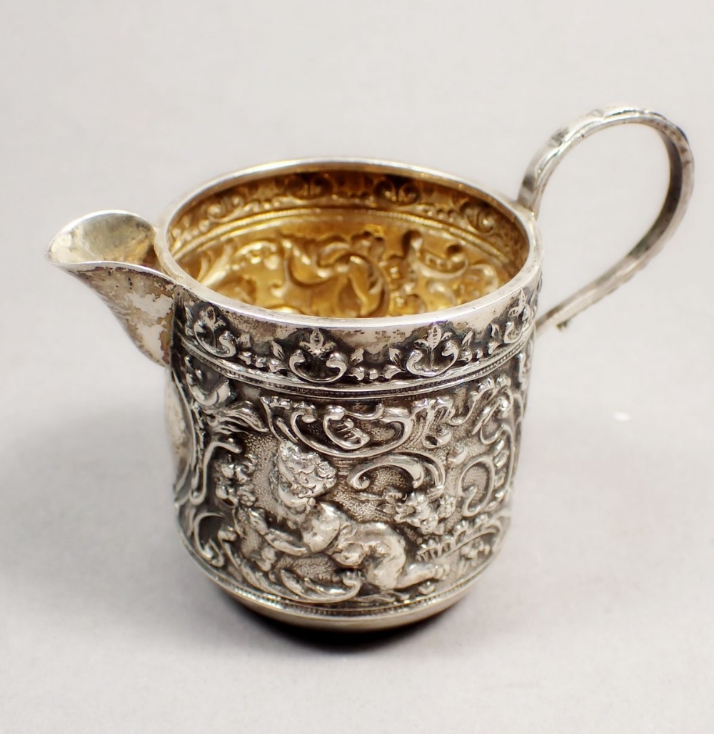 A Victorian silver cream jug with embossed cherub and scrollwork decoration, Chester 1898 and a - Image 2 of 3