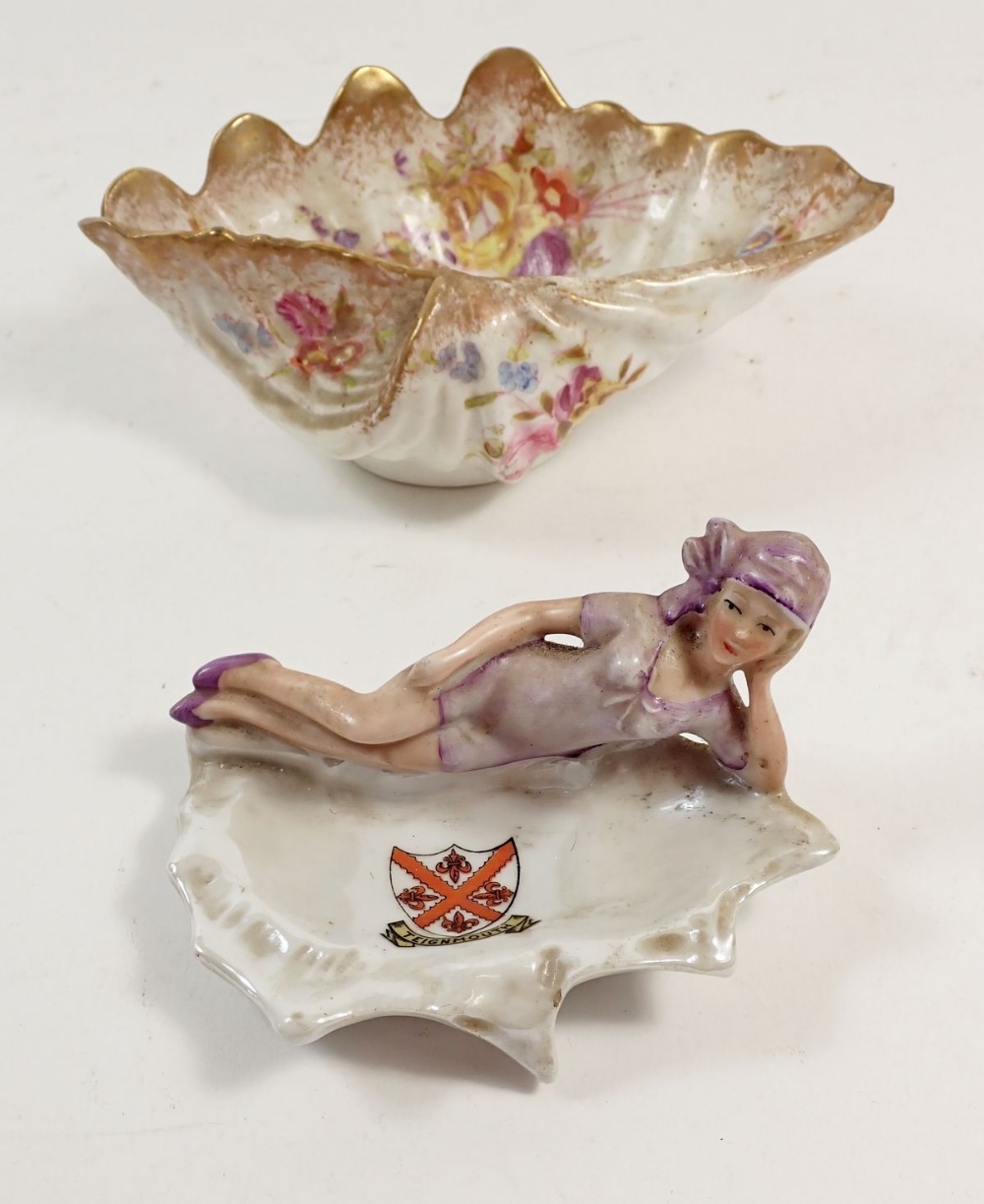 A crested 1930's pin dish with reclining bather and a floral printed shell form dish