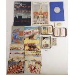 A quantity of Brooke Bond trade cards, military postcards, Portsmouth commemorative book etc