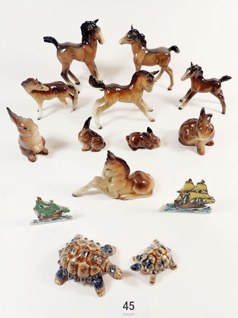 A collection of Beswick and Midwinter foals, a Beswick rabbit family, two Wade snippets, tortoises